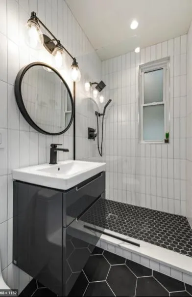 Bathroom with a contemporary design, showcasing a stylish tile floor, clean lines, and a minimalist aesthetic.