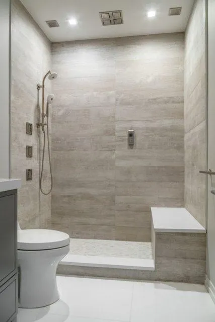 Bathroom featuring a walk-in shower, beige tiles, and a white toilet.