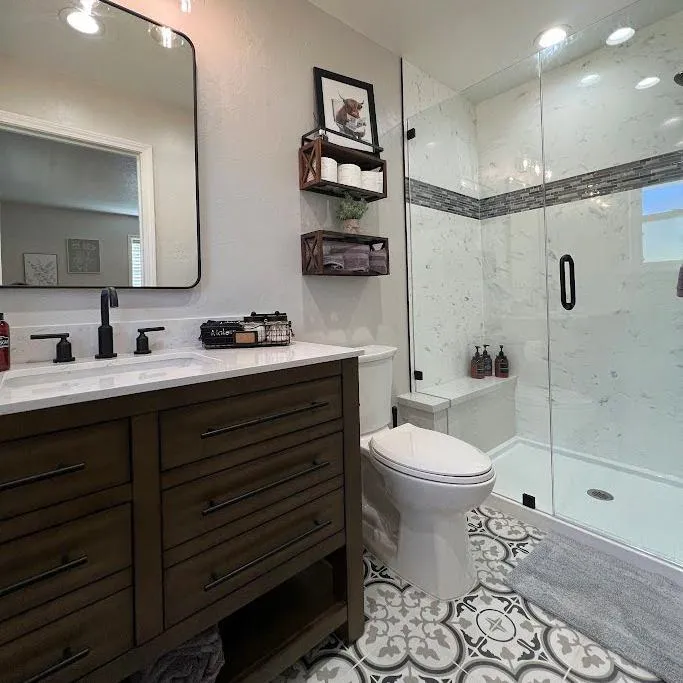 Bathroom renovation with a focus on functionality and style, including a large mirror, sleek fixtures, and a neutral color palette.