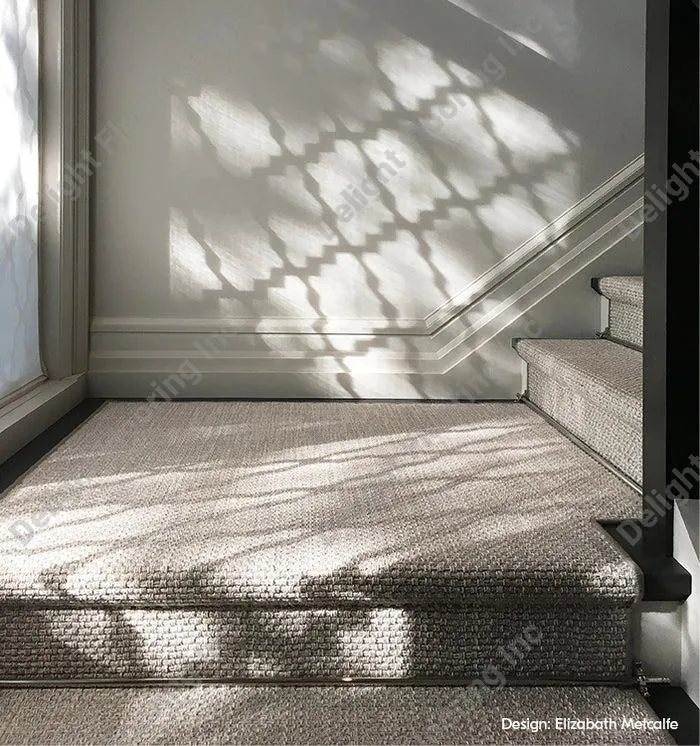 Stylish carpeted stairs with a textured runner, offering a luxurious touch to the home.
