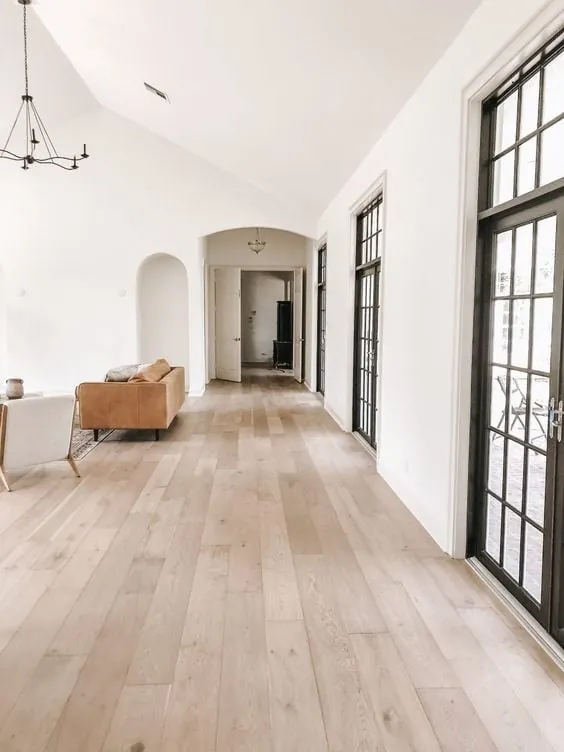 Hardwood flooring features aligned planks and a smooth finished surface across a clean, even installation.