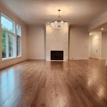 The hardwood flooring is a rich brown color with a smooth finish, featuring a straight plank layout and a glossy sheen.