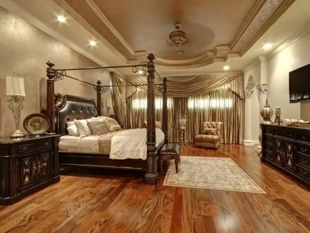 Dark brown herringbone pattern on hardwood flooring with glossy finish.
