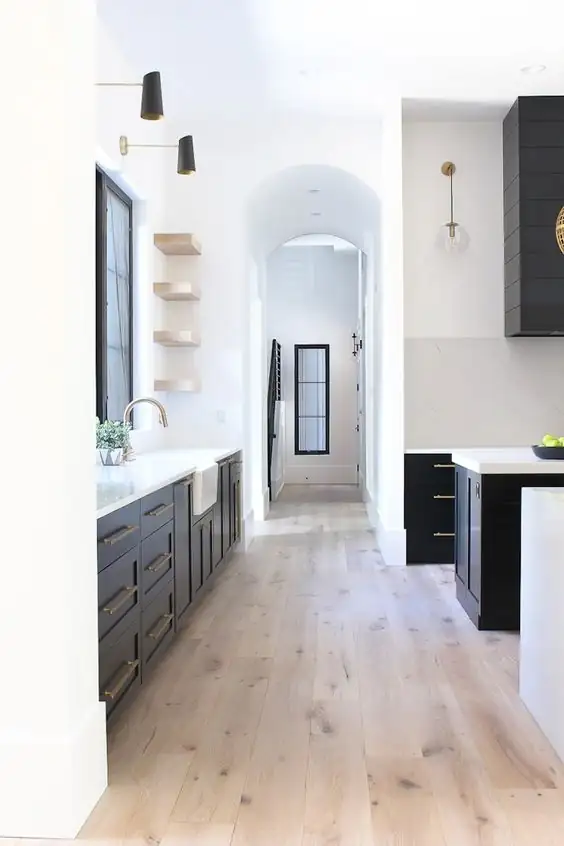A view of a kitchen with hardwood floors.