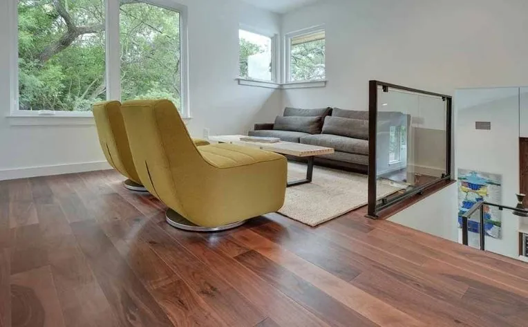 The hardwood flooring is a rich brown color with a smooth finish, featuring a herringbone pattern and a glossy sheen.