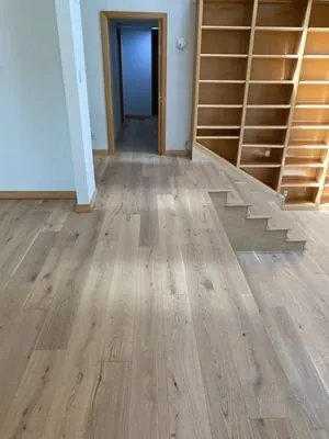 Hardwood flooring features visible grain and a consistent pattern across a clean, even installation.
