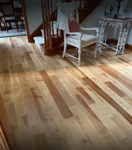 Hardwood flooring features visible grain and a matte finish across a clean, even installation.