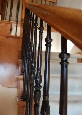 Dark wood staircase with black railing.