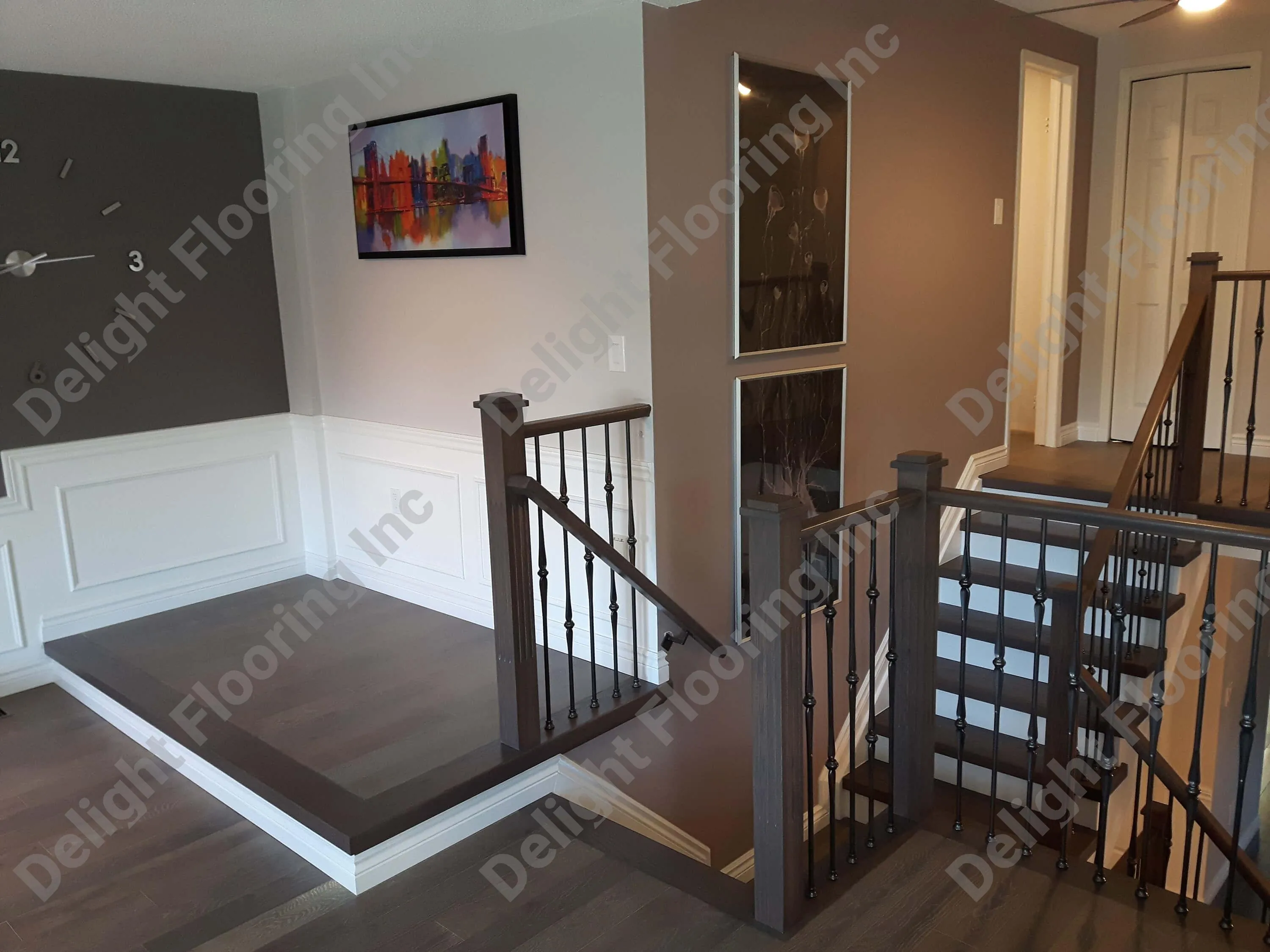 Black railing on hardwood stairs.