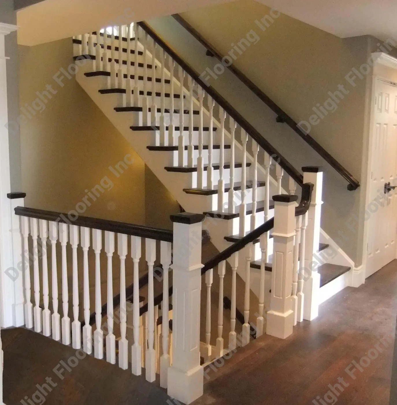 Black and white staircase with hardwood treads.