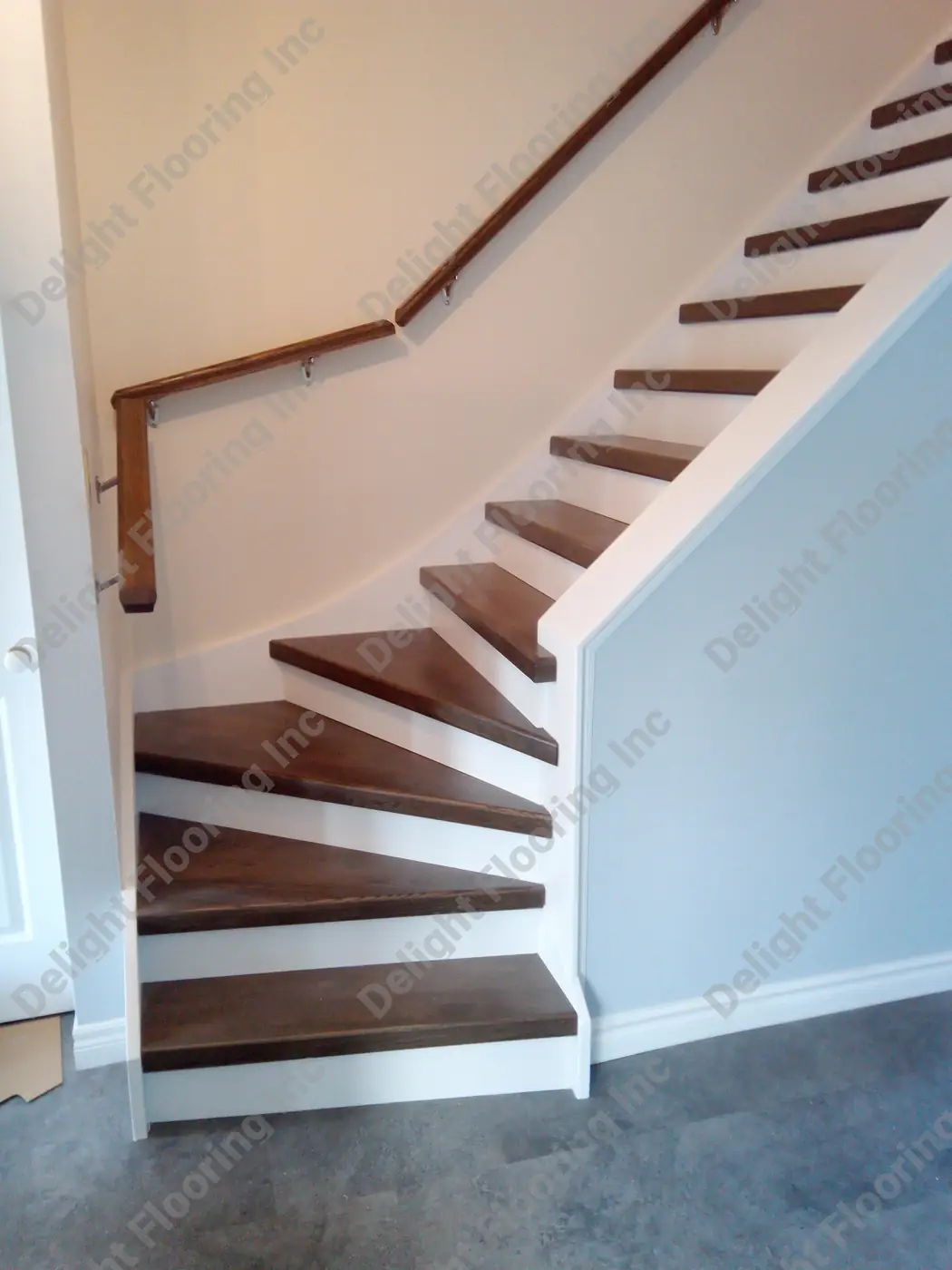 Hardwood staircase showing finished wood treads, risers, and nosing.