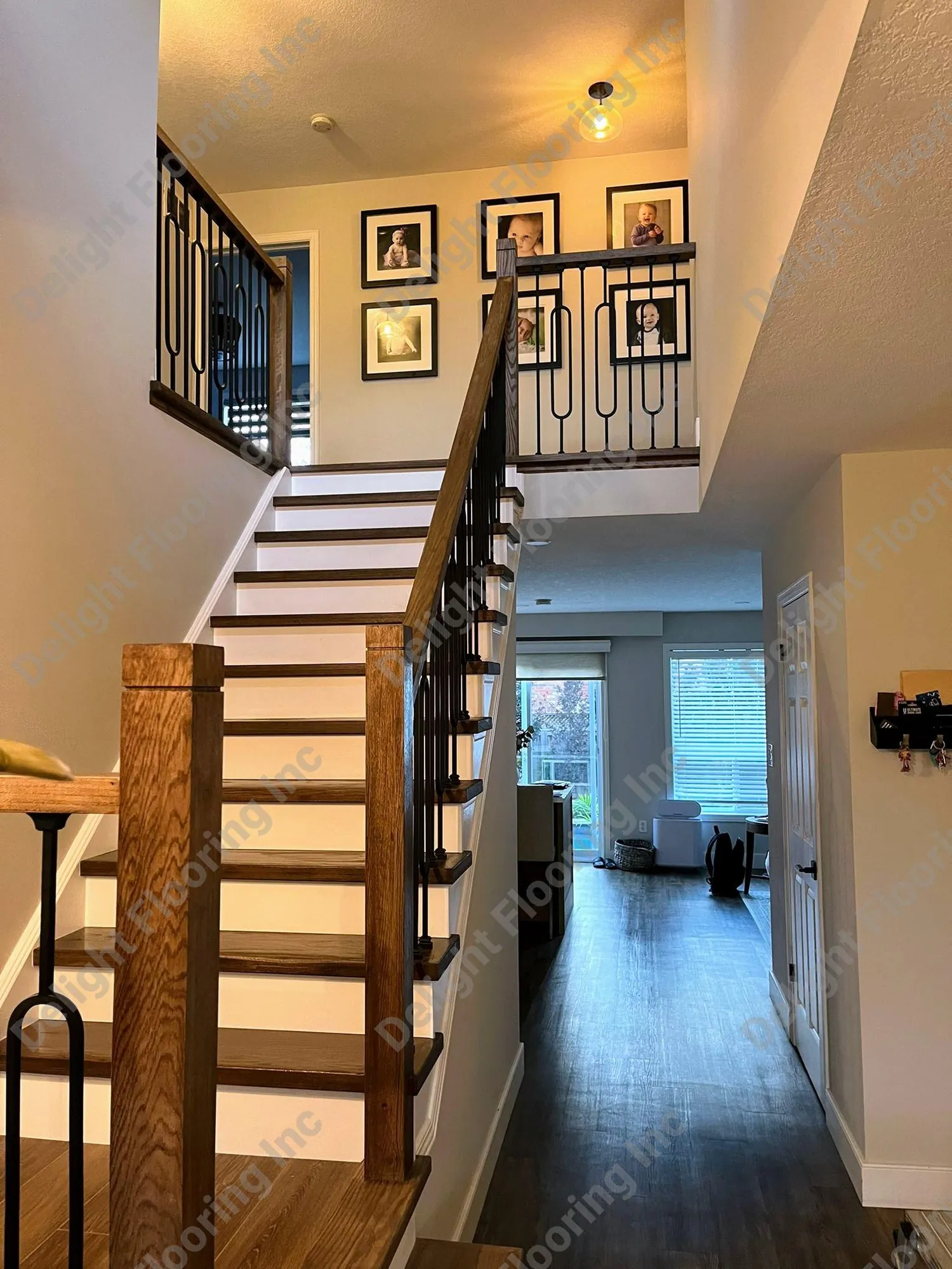Dark wood staircase with black railing.