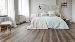 Laminate flooring shows a subtle surface sheen and a consistent pattern across the installed area.