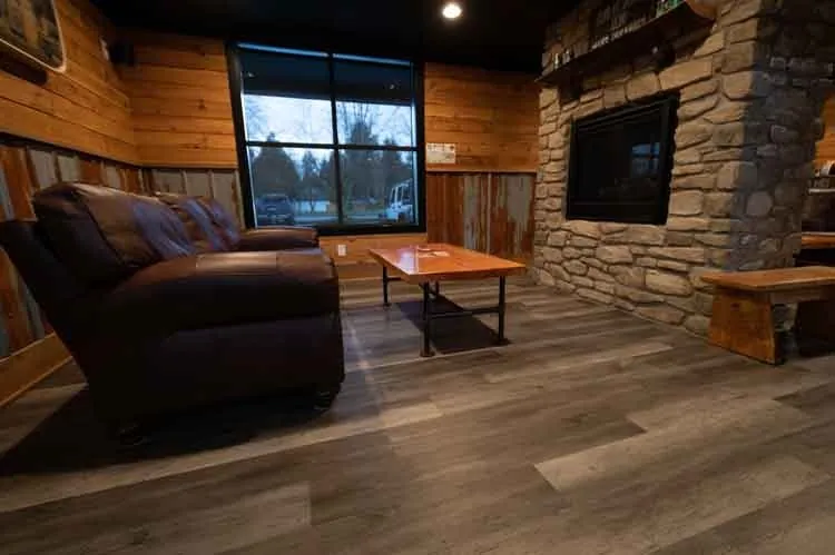 Dark wood laminate flooring with horizontal planks.