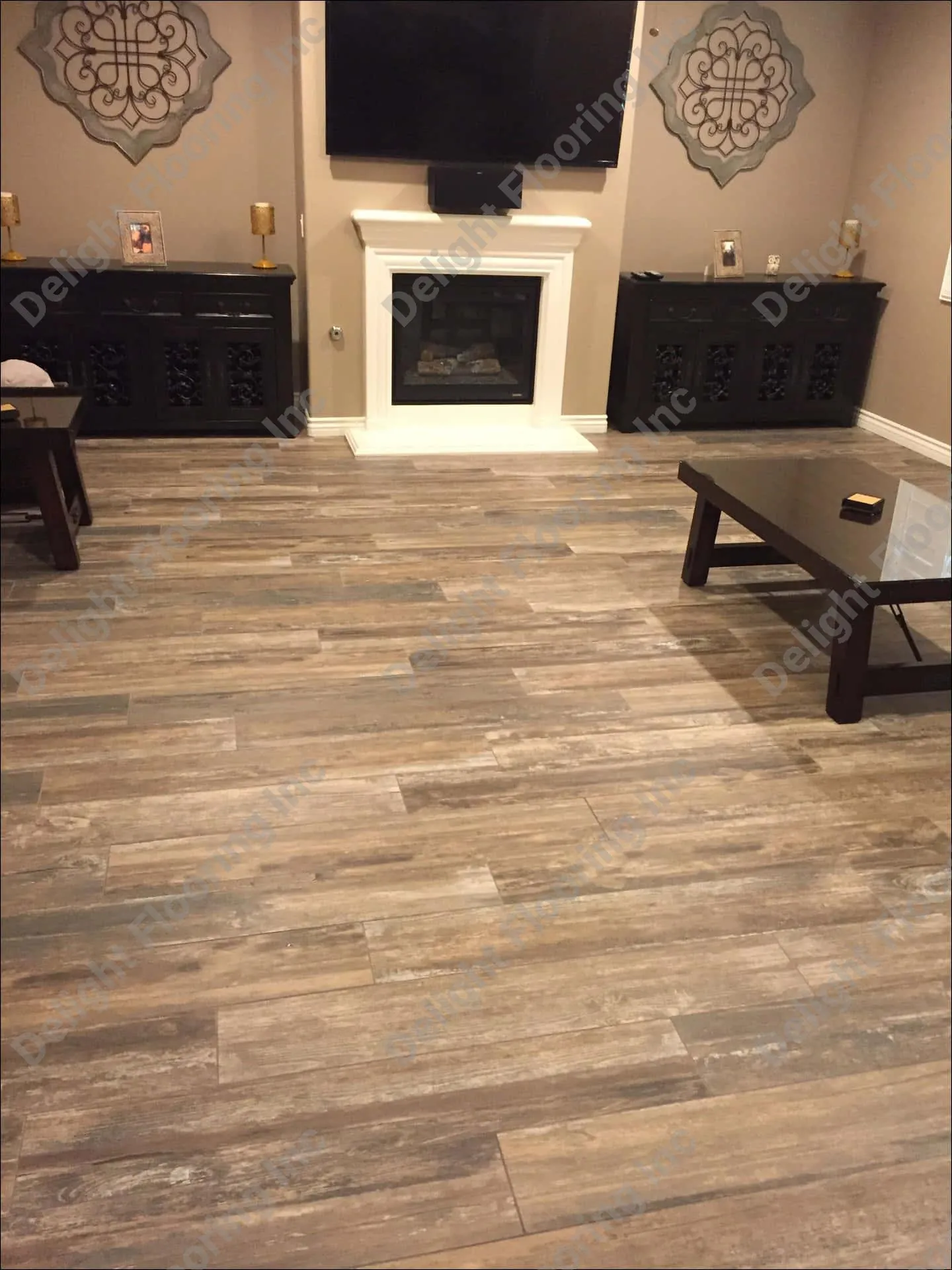 Dark wood-look laminate flooring with seams and transitions.