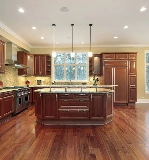 Dark wood laminate flooring in a herringbone pattern.
