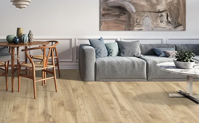 Laminate flooring shows a subtle surface sheen and a consistent pattern across the installed area.