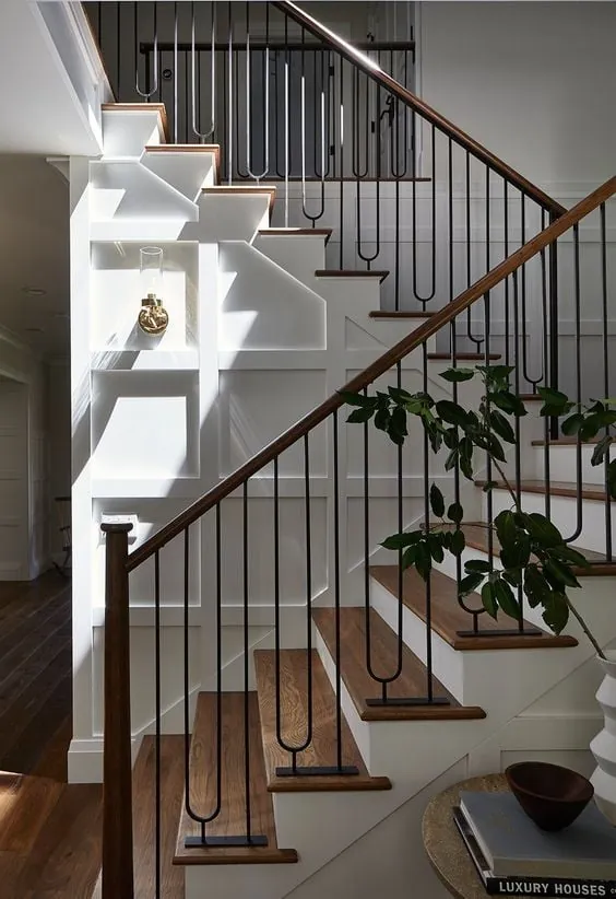 Black metal handrail on white stairs.