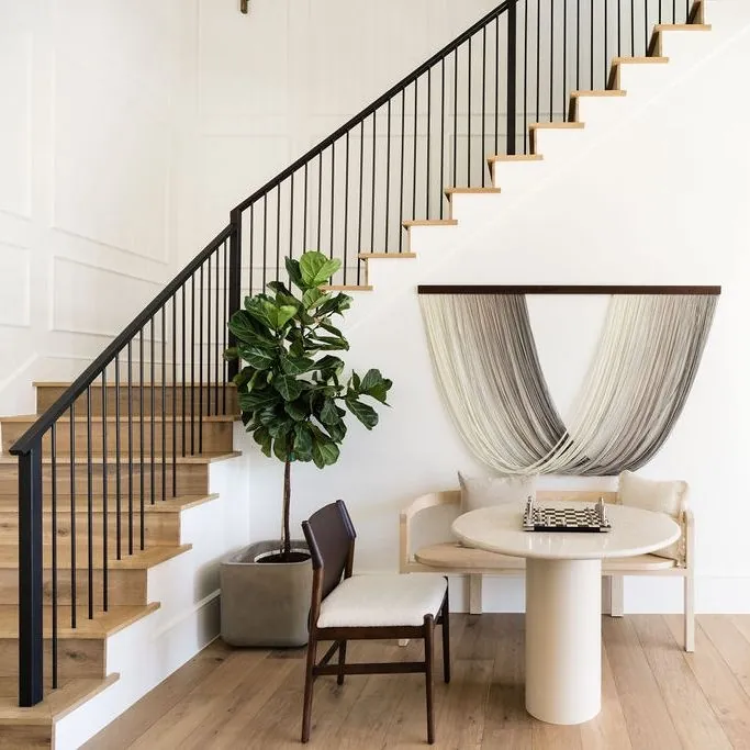 Black metal stair railing with vertical spacing.