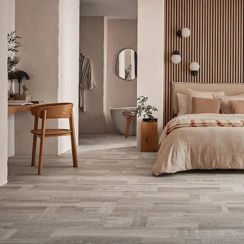 Vinyl plank flooring shows a diagonal layout and a subtle surface sheen across the installed area.